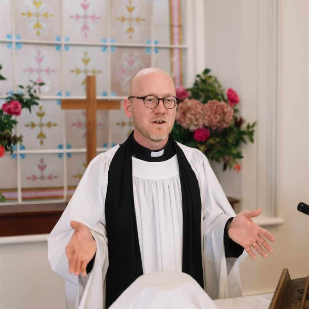Victor preaching in robes