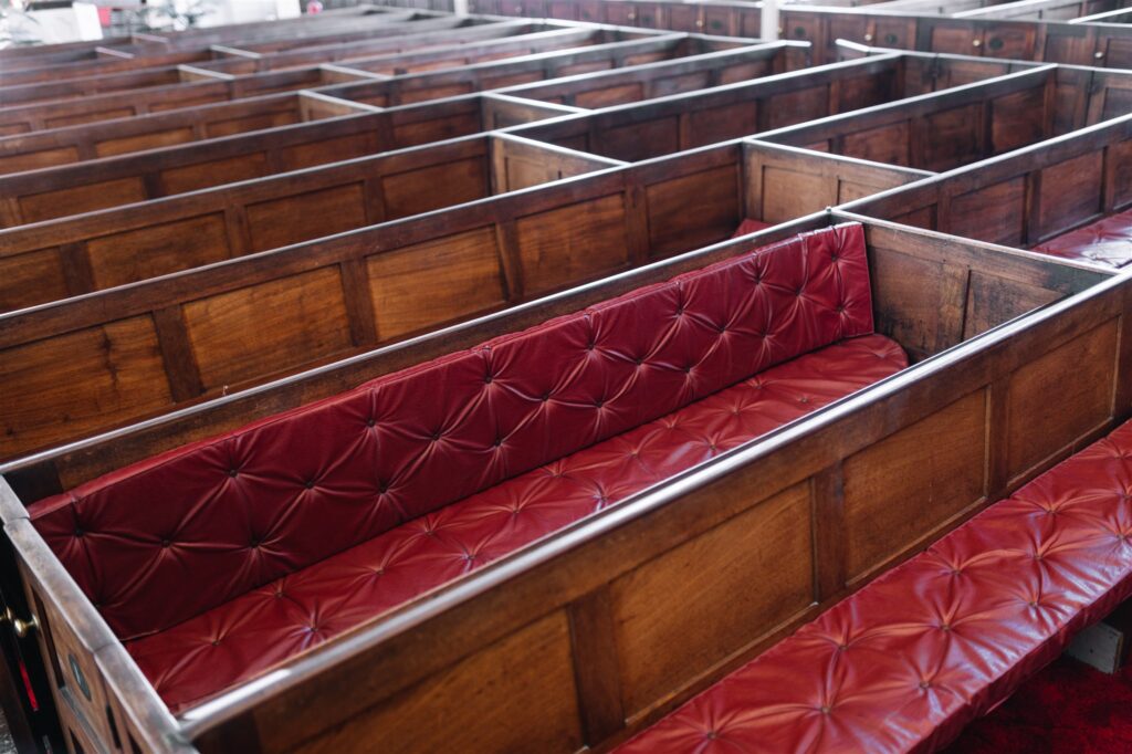 Church pews with red leather seats