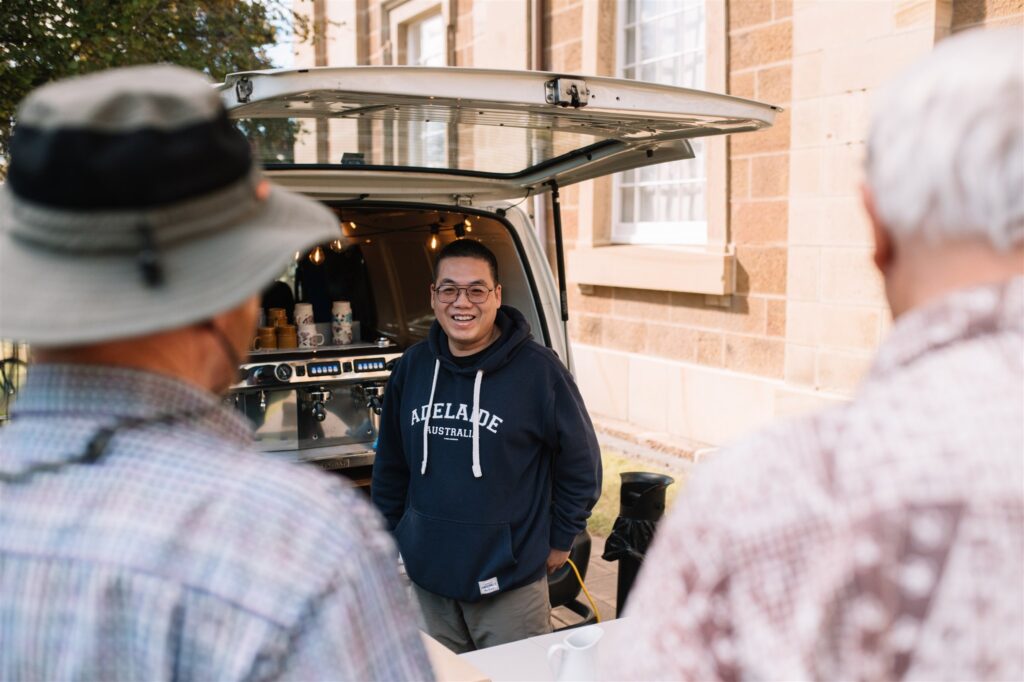 Our barista serving coffee from a van