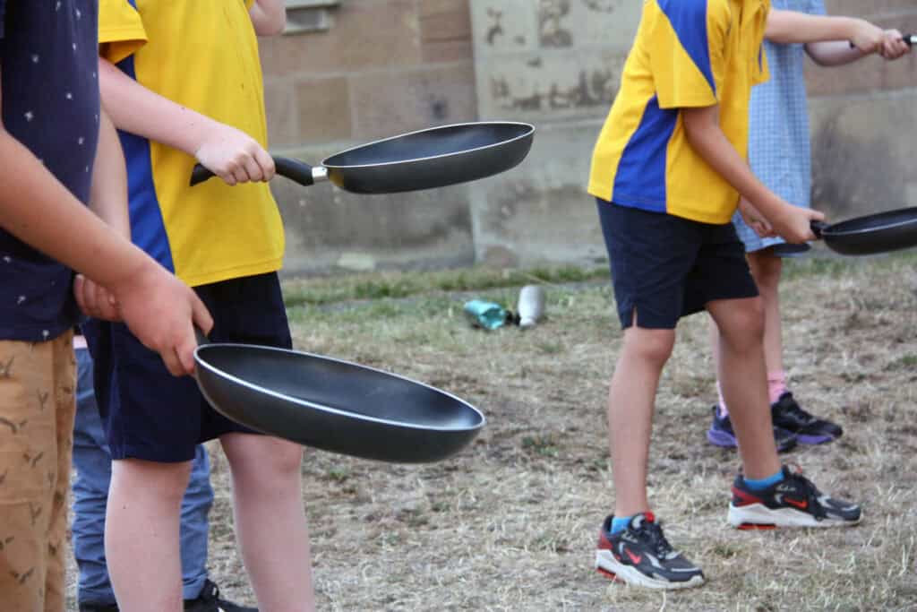 Kids flipping pancakes