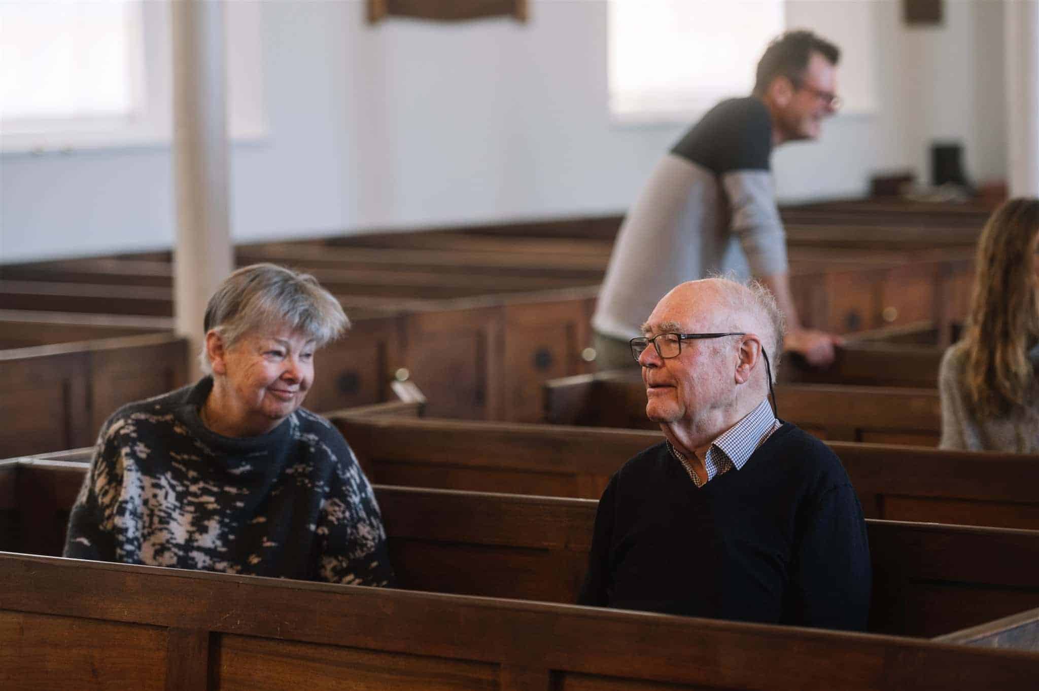 Elderly people chatting at church